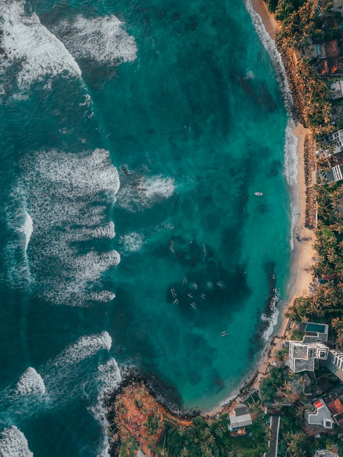 Breathtaking aerial view of Sri Lanka's turquoise waters and lush coastline.